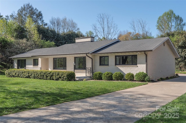 1329 Merrimon Ave, Asheville, NC 28804 - ranch-style house with brick siding, a front yard, a shingled roof, and a chimney