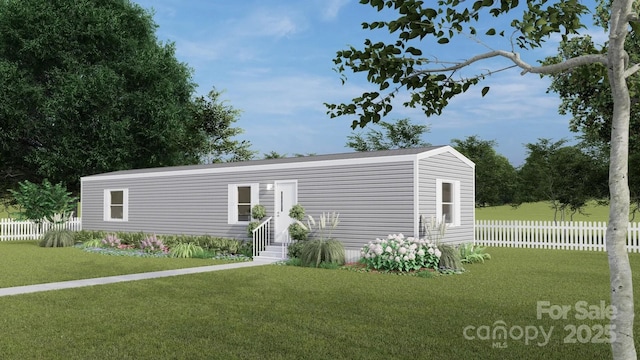 view of front of house with entry steps, fence, and a front lawn