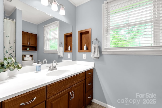 full bathroom with toilet, crown molding, vanity, and baseboards