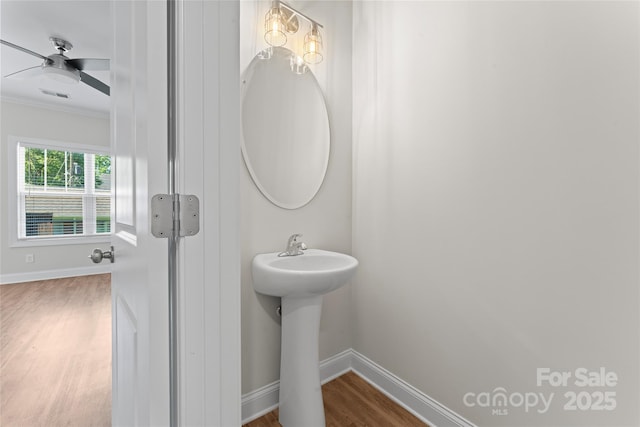 2032 Summey Ave, Charlotte, NC 28205 - bathroom featuring wood finished floors, ornamental molding, baseboards, a ceiling fan, and a sink