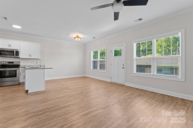 2032 Summey Ave, Charlotte, NC 28205 - unfurnished living room featuring ornamental molding, light wood finished floors, baseboards, ceiling fan, and a sink