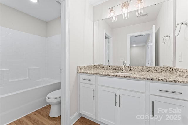 2032 Summey Ave, Charlotte, NC 28205 - full bath featuring wood finished floors, toilet, vanity, and tub / shower combination