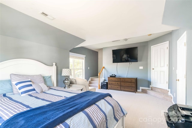 carpeted bedroom with baseboards and visible vents