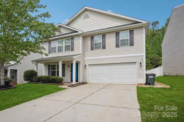 traditional home featuring a porch, fence, driveway, a front yard, and an attached garage
