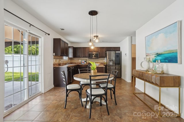 dining area with light tile patterned floors and visible vents