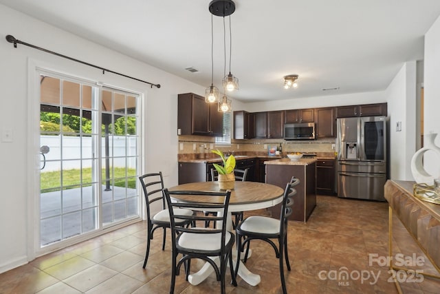 tiled dining room featuring visible vents