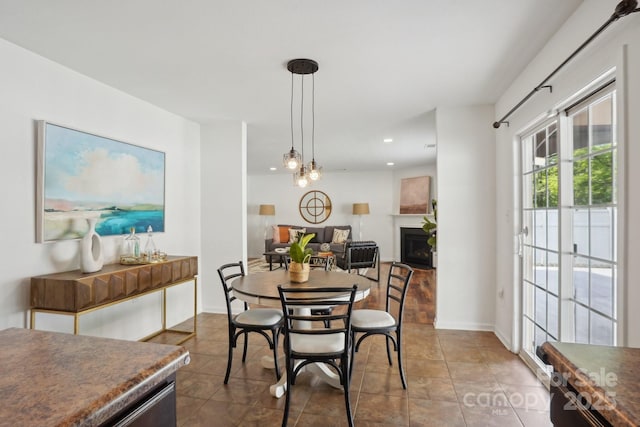 tiled dining space with recessed lighting, baseboards, and a fireplace