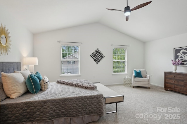 bedroom with carpet floors, a ceiling fan, vaulted ceiling, and multiple windows