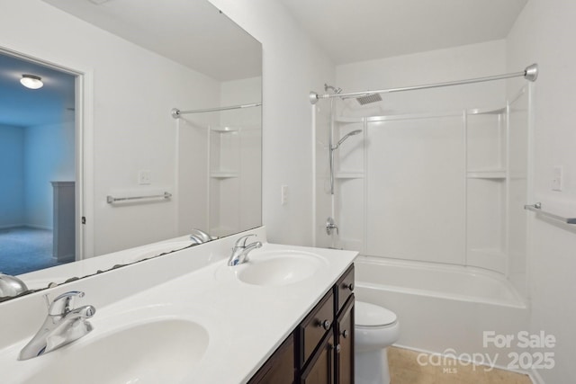 full bathroom featuring bathing tub / shower combination, toilet, double vanity, and a sink