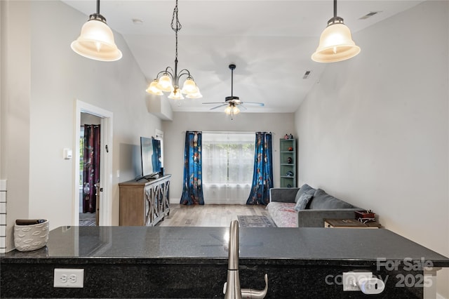 124 Foxden Dr Unit 303, Fletcher, NC 28732 - living area featuring wood finished floors, lofted ceiling, ceiling fan, and a chandelier
