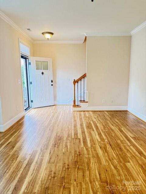 216 Harrison Ln Unit 4, Locust, NC 28097 - foyer with light wood-style floors, crown molding, baseboards, and stairs