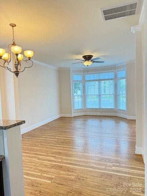 216 Harrison Ln Unit 4, Locust, NC 28097 - unfurnished living room with crown molding, visible vents, light wood-style floors, baseboards, and ceiling fan with notable chandelier