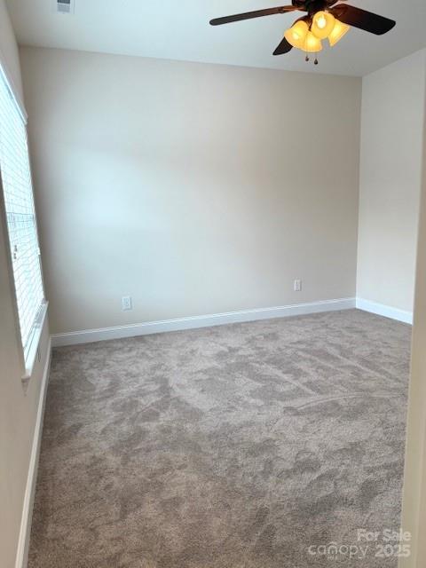 216 Harrison Ln Unit 4, Locust, NC 28097 - spare room featuring baseboards, a ceiling fan, and carpet