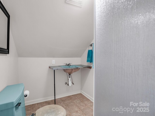 940 Hugh Champion Rd, Tryon, NC 28782 - half bathroom with visible vents, toilet, vaulted ceiling, and baseboards