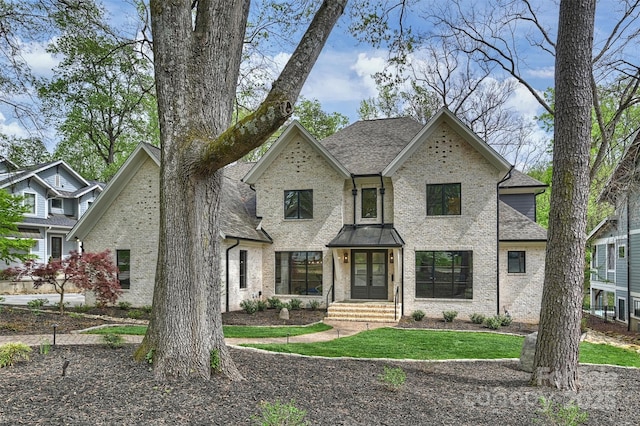 438 Wonderwood Dr, Charlotte, NC 28211 - view of front facade featuring roof with shingles, brick siding, and french doors