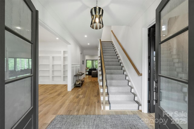 438 Wonderwood Dr, Charlotte, NC 28211 - entryway featuring crown molding, recessed lighting, stairway, and light wood-style floors