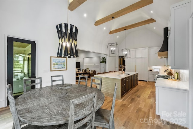 438 Wonderwood Dr, Charlotte, NC 28211 - dining area with beamed ceiling, light wood-style flooring, high vaulted ceiling, and a chandelier
