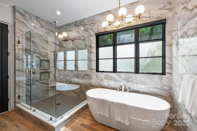 438 Wonderwood Dr, Charlotte, NC 28211 - full bathroom with a shower stall, wood finished floors, a chandelier, and a soaking tub