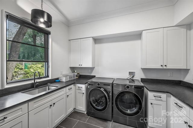 438 Wonderwood Dr, Charlotte, NC 28211 - washroom with dark tile patterned floors, a sink, ornamental molding, cabinet space, and washing machine and clothes dryer