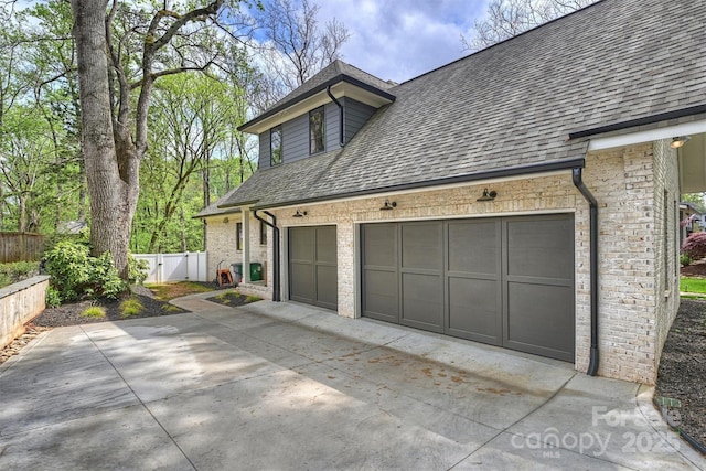 438 Wonderwood Dr, Charlotte, NC 28211 - view of home's exterior with fence, a garage, driveway, and roof with shingles