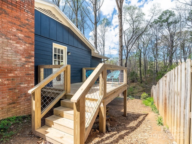 deck featuring fence and stairs