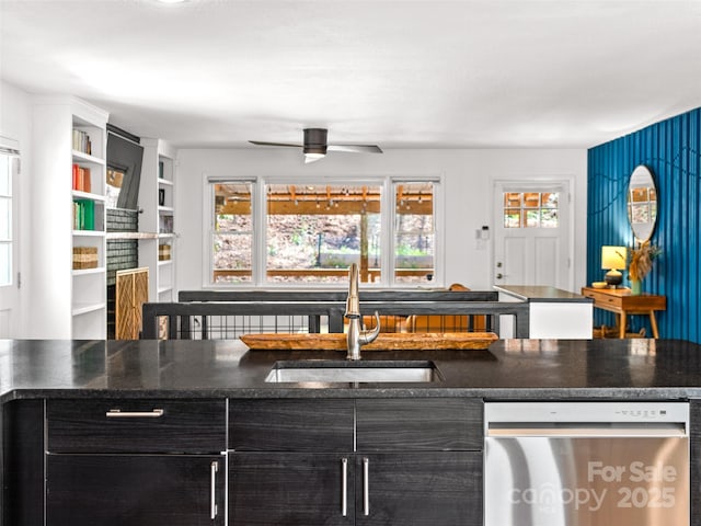 kitchen with ceiling fan, dishwasher, a sink, and dark countertops