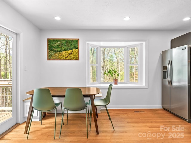 dining room with visible vents, light wood-type flooring, and recessed lighting