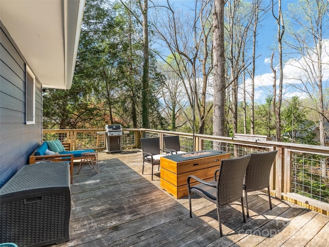 wooden terrace featuring a grill