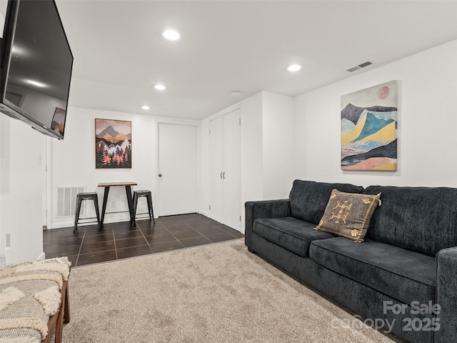 living room featuring recessed lighting, dark tile patterned floors, visible vents, and dark carpet