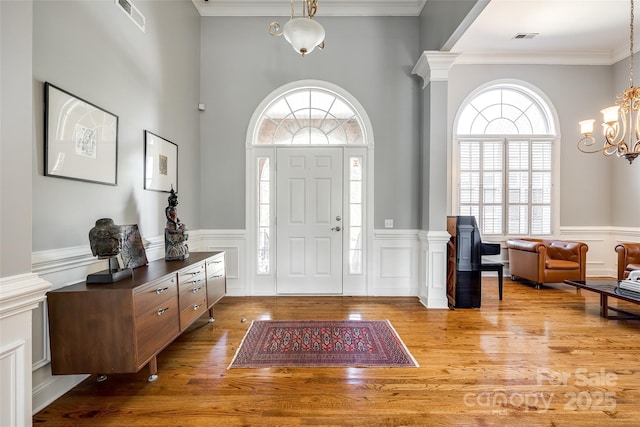 1126 Blowing Rock Cv, Fort Mill, SC 29708 - foyer with visible vents, a wainscoted wall, an inviting chandelier, and wood finished floors