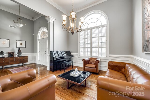 1126 Blowing Rock Cv, Fort Mill, SC 29708 - living area with a chandelier, plenty of natural light, crown molding, and wood finished floors
