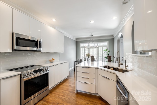 1126 Blowing Rock Cv, Fort Mill, SC 29708 - kitchen with a sink, white cabinets, appliances with stainless steel finishes, and crown molding