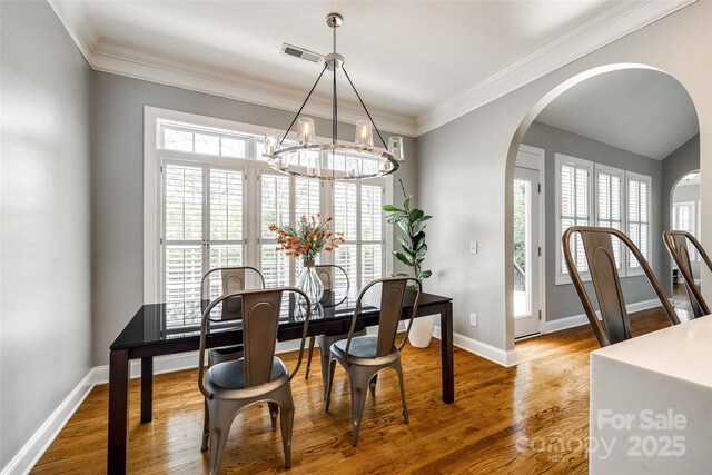 1126 Blowing Rock Cv, Fort Mill, SC 29708 - dining space featuring a wealth of natural light, arched walkways, visible vents, and wood finished floors