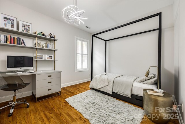 1126 Blowing Rock Cv, Fort Mill, SC 29708 - bedroom featuring dark wood-style flooring, visible vents, baseboards, and a notable chandelier