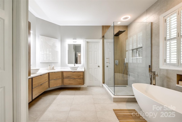 1126 Blowing Rock Cv, Fort Mill, SC 29708 - bathroom featuring double vanity, a stall shower, a soaking tub, tile patterned floors, and a sink