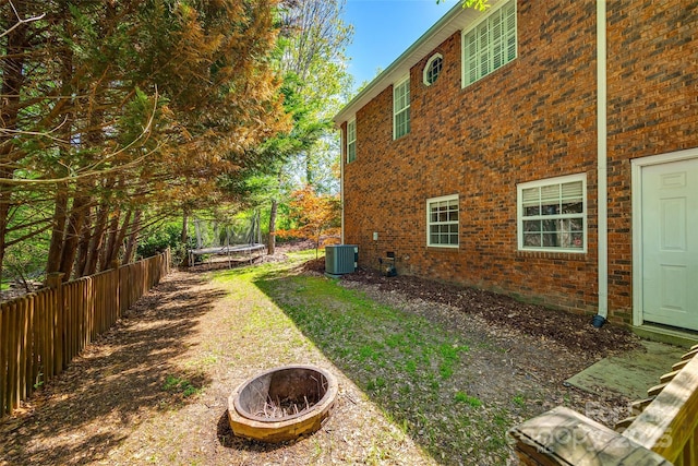 1126 Blowing Rock Cv, Fort Mill, SC 29708 - view of yard featuring a trampoline, central AC, fence, and an outdoor fire pit