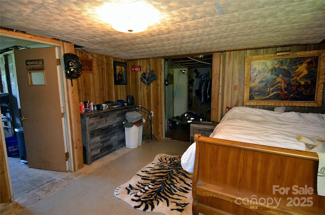 bedroom with wood walls
