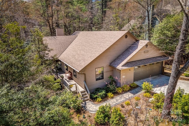 drone / aerial view featuring a wooded view