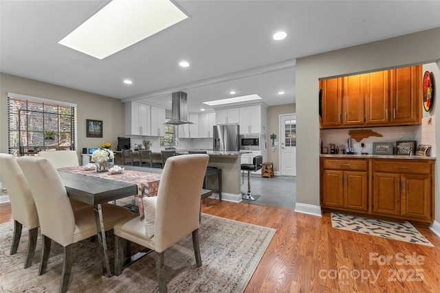 dining area featuring recessed lighting and light wood-type flooring