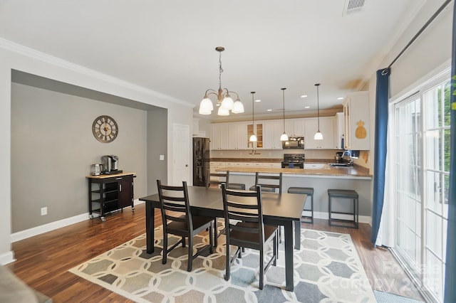 dining room with baseboards, visible vents, a chandelier, recessed lighting, and dark wood-type flooring