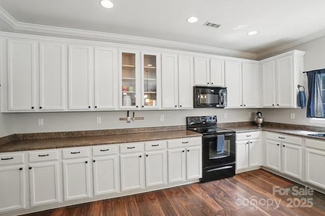 kitchen with white cabinets, dark countertops, visible vents, black appliances, and dark wood-style flooring