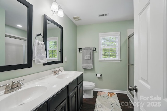 full bathroom featuring visible vents, toilet, baseboards, and a sink