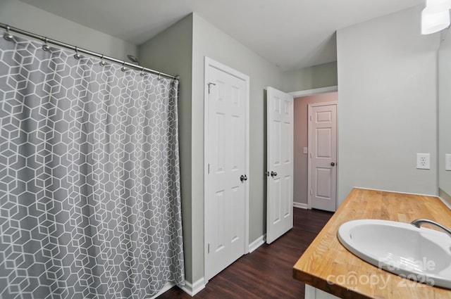 full bathroom with wood finished floors, vanity, and a shower with curtain