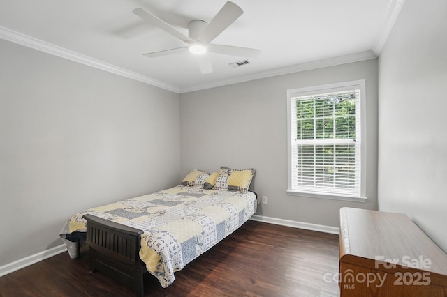 bedroom featuring baseboards, wood finished floors, visible vents, and ornamental molding
