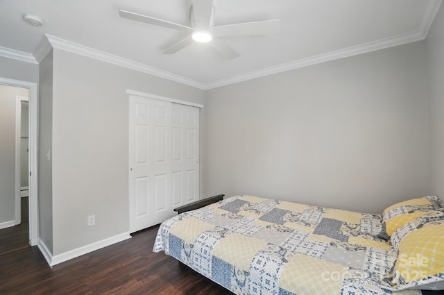 bedroom featuring baseboards, wood finished floors, a closet, and ornamental molding