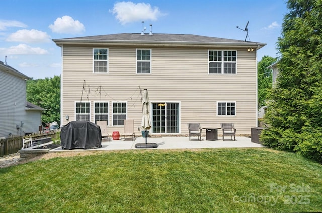 rear view of house with a lawn, fence, and a patio area