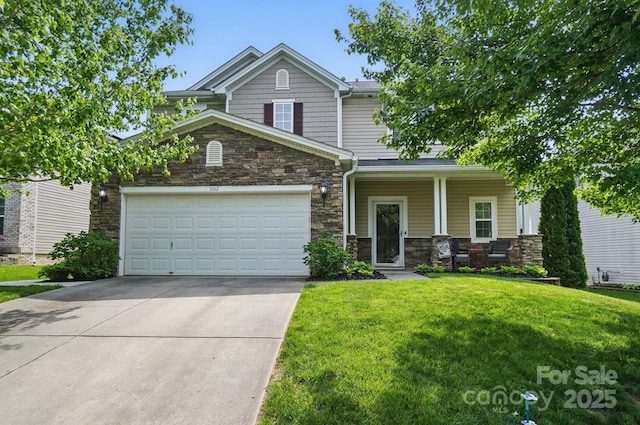 view of front of property featuring driveway, stone siding, covered porch, a front lawn, and a garage