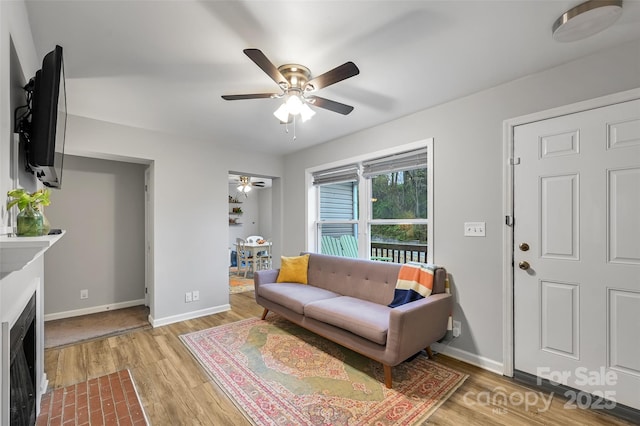 212 Short Michigan Ave, Asheville, NC 28806 - living area with light wood finished floors, baseboards, and a ceiling fan