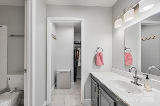 212 Short Michigan Ave, Asheville, NC 28806 - bathroom featuring vanity, baseboards, a spacious closet, tile patterned flooring, and toilet