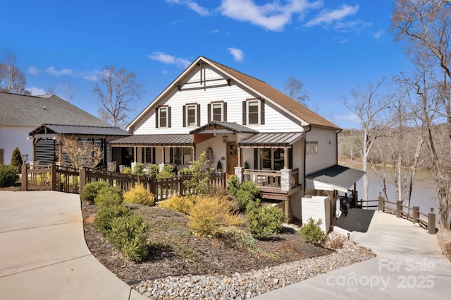 5888 Wood Duck Way, Catawba, NC 28609 - view of front of home featuring metal roof, a standing seam roof, fence, and a deck with water view
